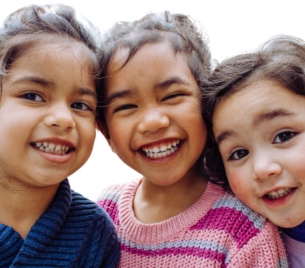 Three young girls smiling together