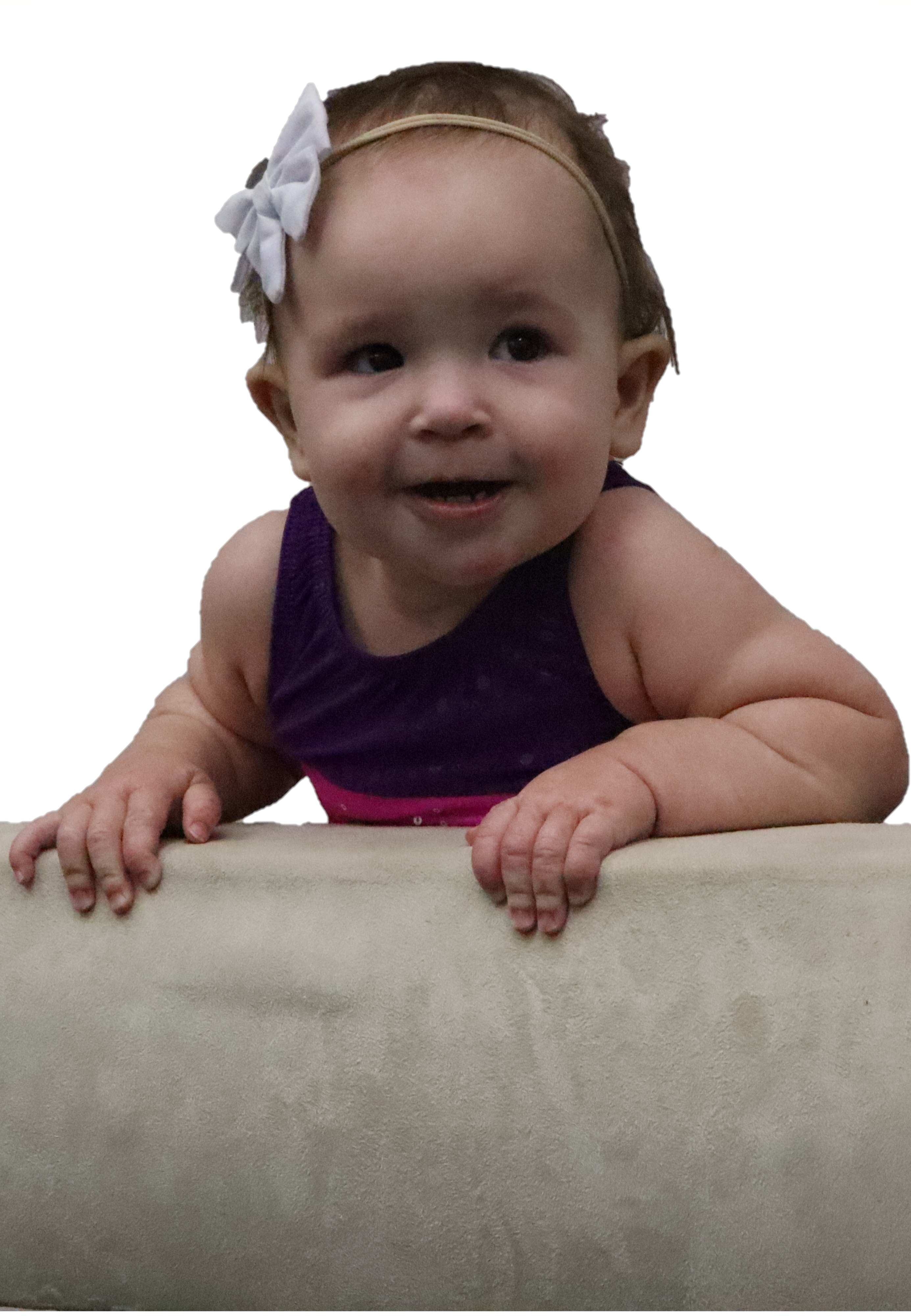 Happy baby climbing up on balance beam